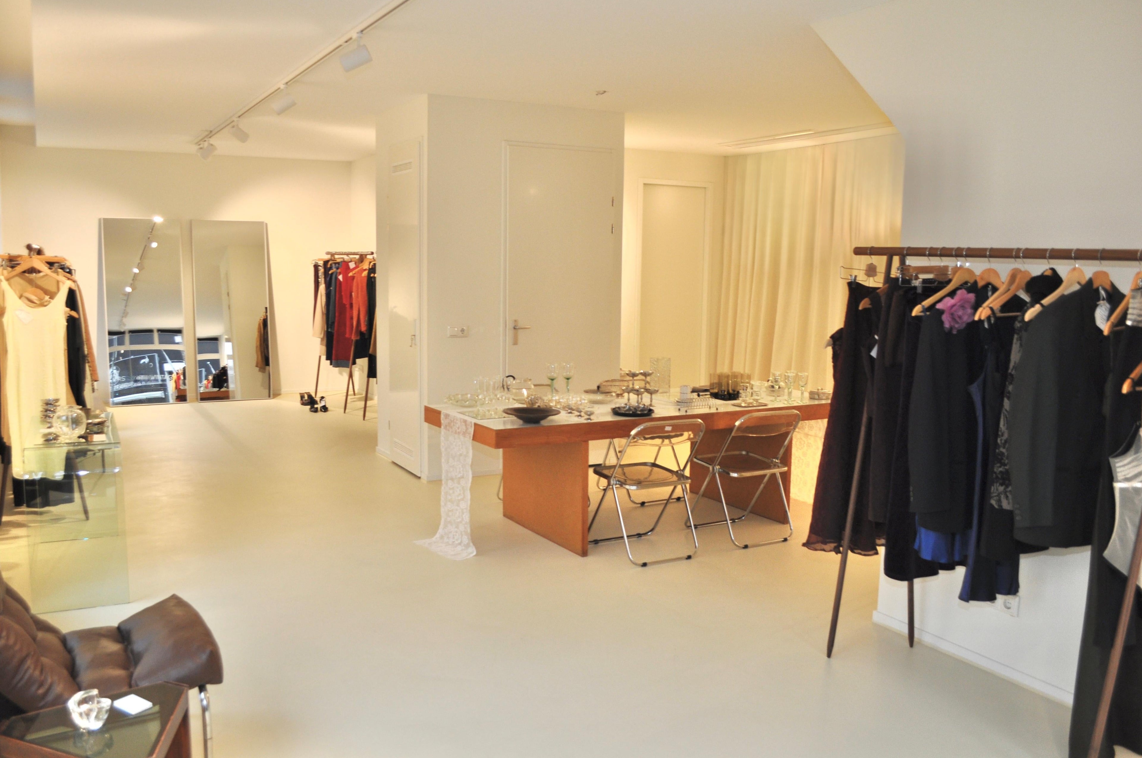 Modern interior design showroom with furniture and clothing display